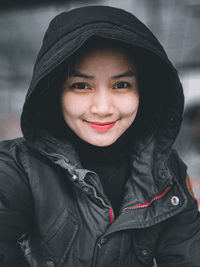 Portrait of smiling mid adult woman in snow