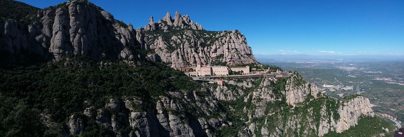 Panoramic view of rocks and trees against sky