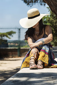 Full length of a girl sitting outdoors