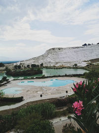 Scenic view of lake against cloudy sky