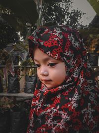 Close-up portrait of cute girl looking away