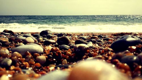 Pebbles on beach against sky