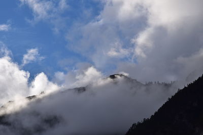 Low angle view of volcanic mountain against sky