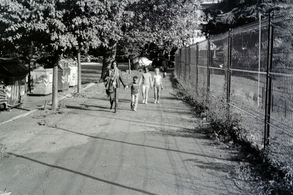 tree, the way forward, full length, walking, footpath, fence, rear view, railing, park - man made space, lifestyles, bicycle, outdoors, day, shadow, childhood, diminishing perspective, walkway, leisure activity