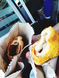 Close-up of cropped hands holding street food