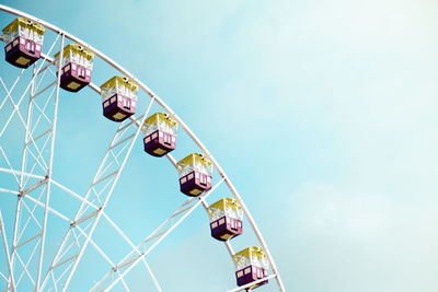 Low angle view of ferris wheel against sky