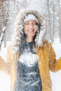 Portrait of a smiling woman in snow