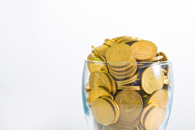 High angle view of coins in glass container