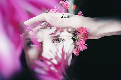 Portrait of woman holding pink flower