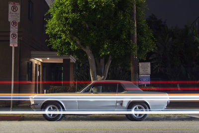 Vintage classic american muscle  pick up truck car and light trails  in venice beach, california 