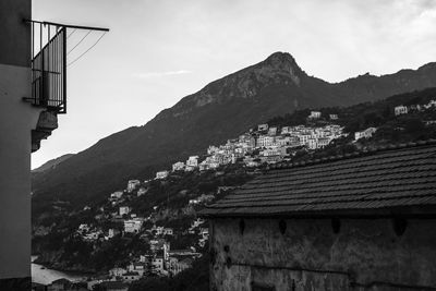 Townscape by mountains against sky