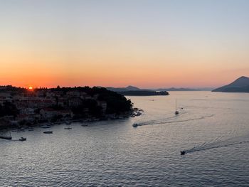 Scenic view of sea against clear sky during sunset