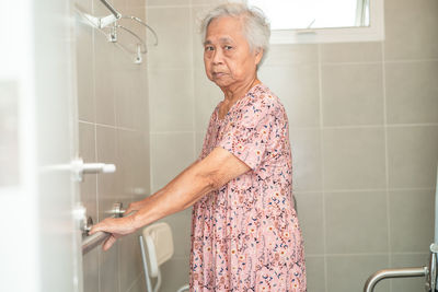 Asian elderly woman patient use toilet bathroom handle security 