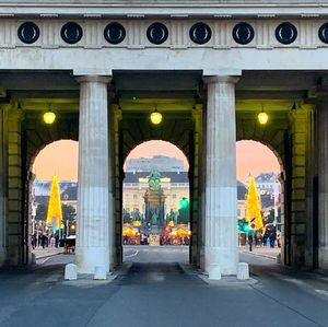 View of city street and buildings seen through colonnade