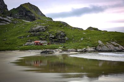 Scenic view of lake by building against sky