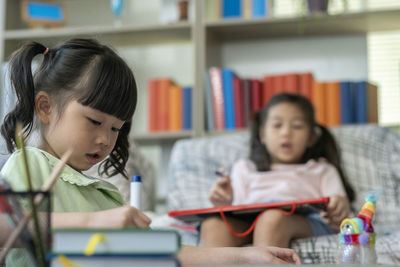 Cute girl sitting on book