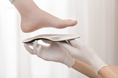 Hands of woman measuring sole