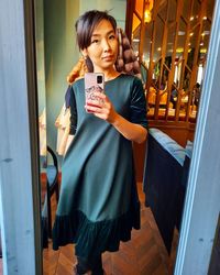 Portrait of woman doing selfie in mirror