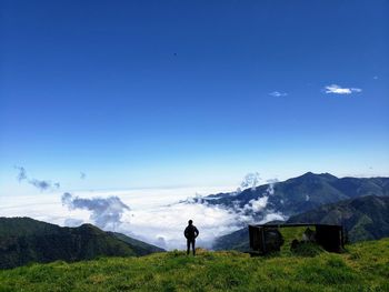 Rear view of man standing on mountain