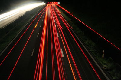 High angle view of light trails on road at night