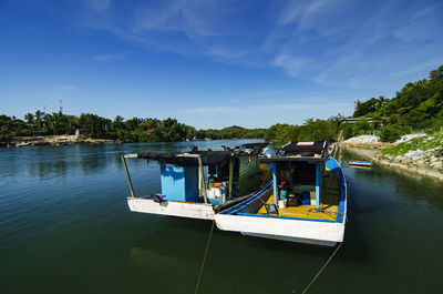 Boat sailing in river against sky