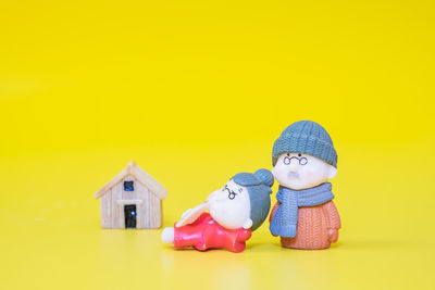 Close-up of stuffed toy against yellow background