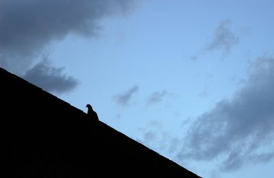 Low angle view of building against cloudy sky