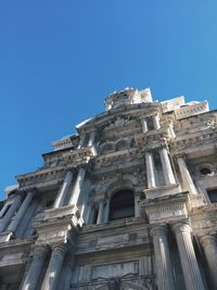 Low angle view of historical building against clear blue sky