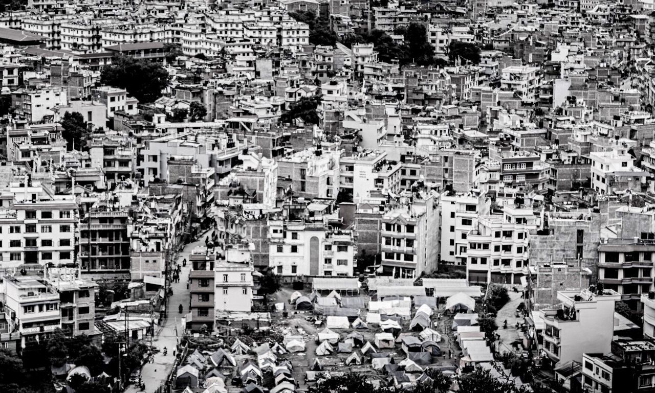 building exterior, architecture, built structure, crowded, high angle view, city, full frame, residential district, cityscape, residential structure, residential building, backgrounds, city life, day, large group of people, outdoors, roof, elevated view, town, townscape