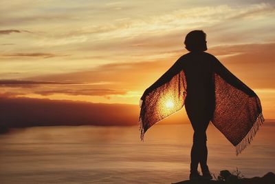 Silhouette of woman at sunset