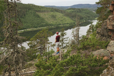 Hiker standing near lake