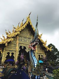 Low angle view of statue against cloudy sky