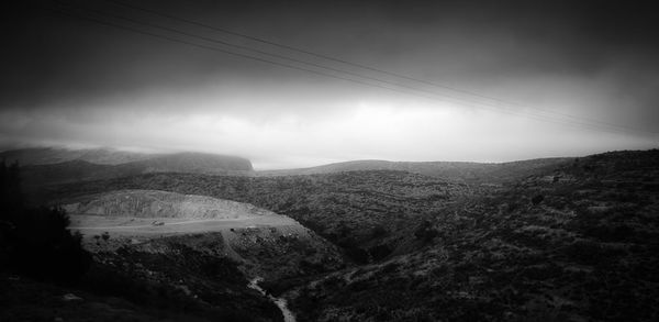 Scenic view of mountains against cloudy sky