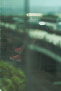 Blurred motion of man seen through glass window