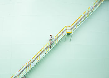 Low angle view of engineer walking on steps