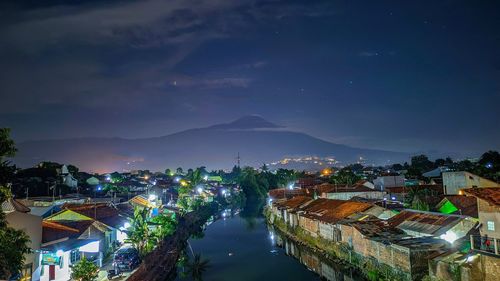 High angle view of illuminated buildings in city at night