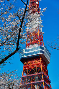 Low angle view of tower against sky with cherry blossom