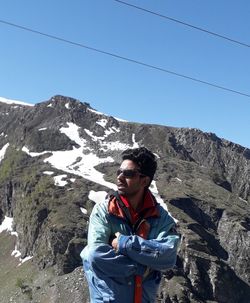 Full length of man in mountains against clear blue sky