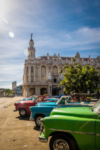 Cars on street against sky