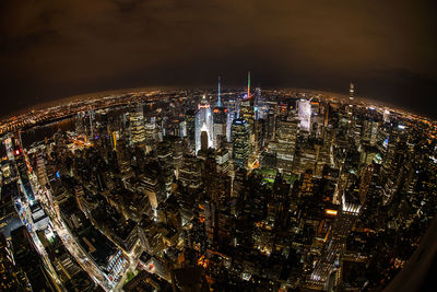 High angle view of city lit up at night