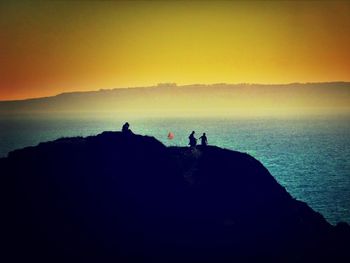 Silhouette of people at sunset