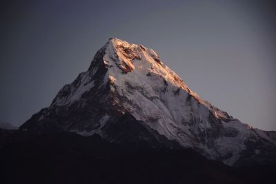 Low angle view of snowcapped mountain against sky