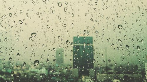 Full frame shot of wet glass window in rainy season
