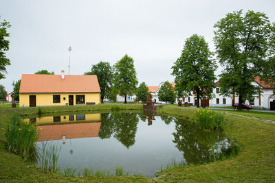 Canal by building against sky