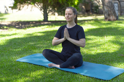 Portrait of young woman exercising in park