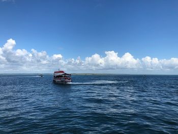 Boat sailing in sea against sky