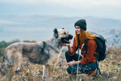 Full length of young woman with dog