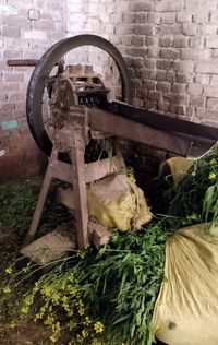 Close-up of old machinery against wall