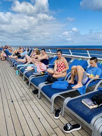 People sitting on boat against sky