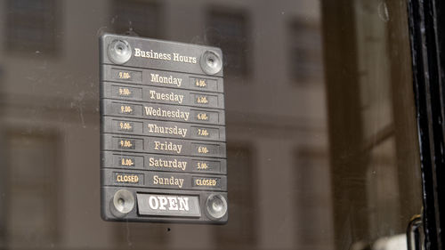 Opening times sign in a shop window